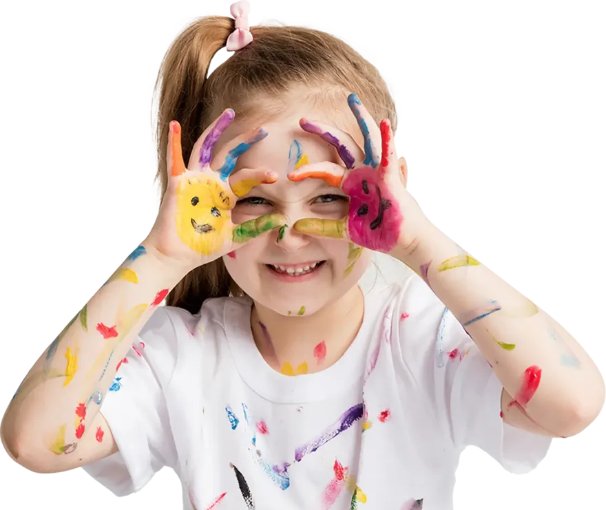 A young girl joyfully shows off her hands covered in vibrant, colorful paint, smiling with creativity and excitement.